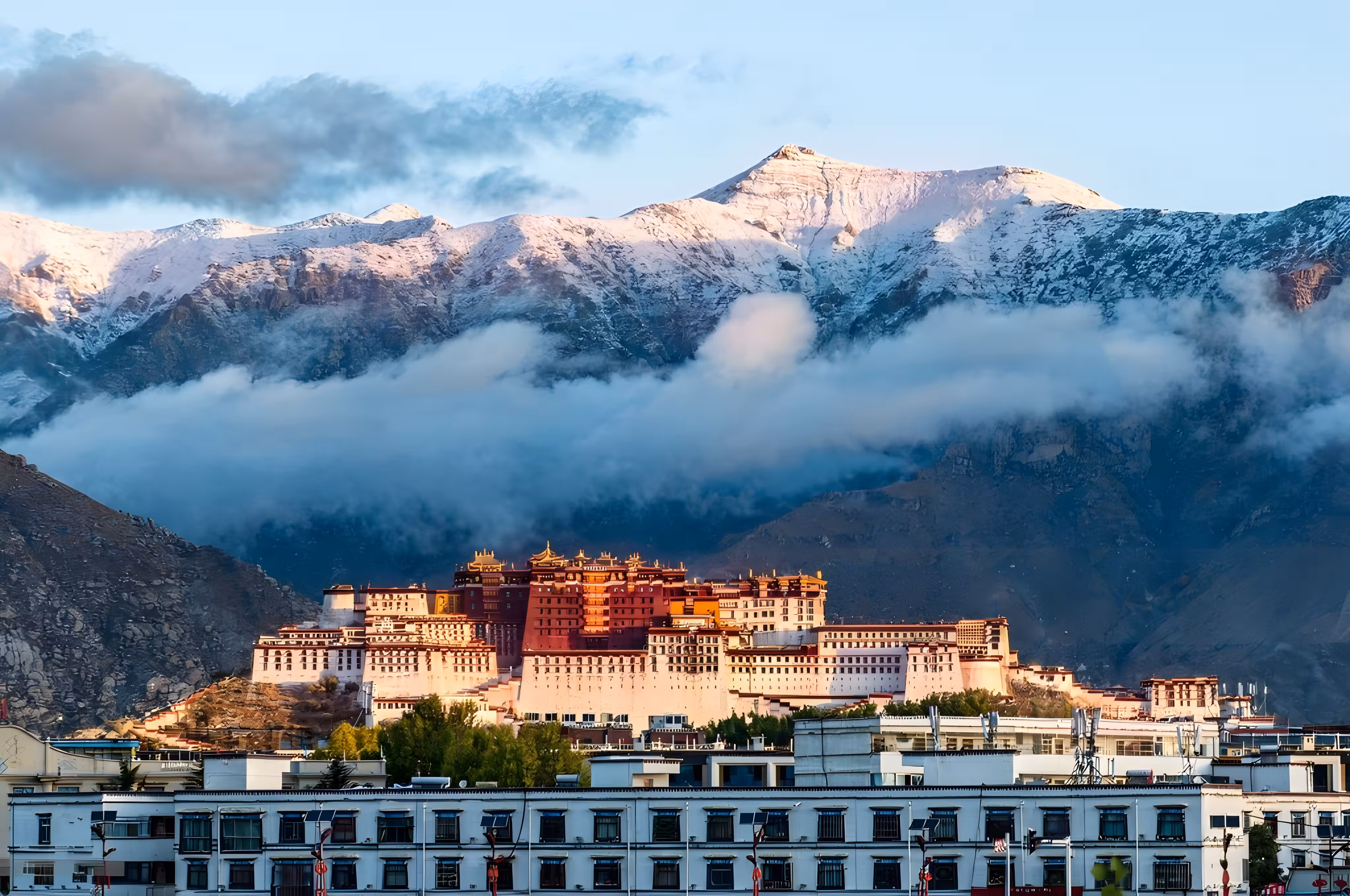 Traditional Tibetan architecture and cityscape in Lhasa with mountains in the background